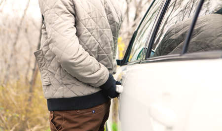 the thief is trying to open the car door