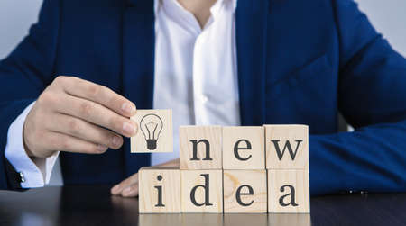 businessman with wooden cubes with an inscription IDEA; business conceptの写真素材