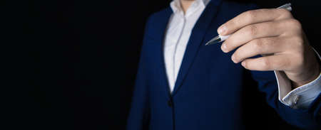 businessman against black background writes on the screenの写真素材
