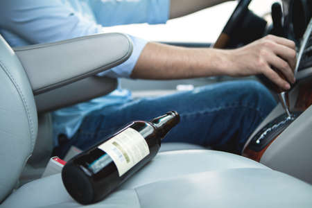 Drunk young man driving a carの写真素材