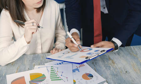 team working with sales schedules in the officeの写真素材