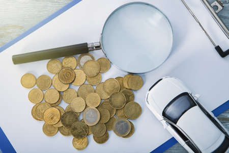 car search; trifle, auto and magnifier on the table