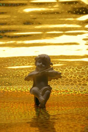 Angel on the abstract golden backgroundの写真素材