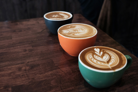 Latte on an old brown wood table.の写真素材