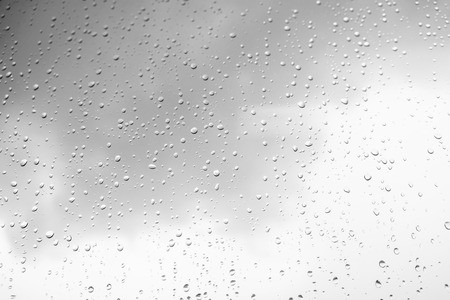 Heavy rain outside the window makes the glass island water.の写真素材