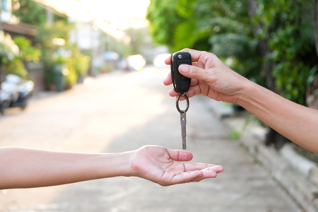 Young businessmen submit car keys toの写真素材