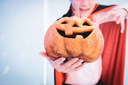 Man  with pumpkin. Scary Halloween. Devil.  Happy Halloween. Evil wizard hold Halloween pumpkin.の写真素材