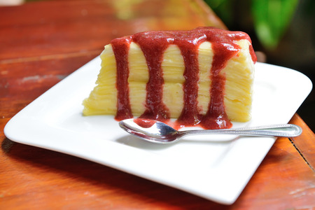 Crepe cake with strawberry sauce