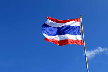 Waving Thai flag with blue sky background の写真素材
