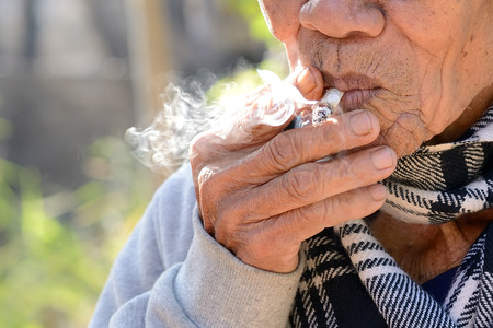 Old man smokingの写真素材