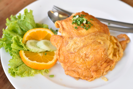 Top view of delicious hot jusmine rice topping with omelette with pork or minced pork in omelette serve on white plate の写真素材