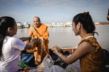 OCT 10: 2017 When the End of Buddhist Lent Day come, The Buddhist give food offerings to Buddhist monks,The Chao Phraya River Waterfront community in Thailand.のeditorial素材