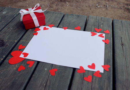 Red and white gift paper on wooden table. Valentine's day.の写真素材