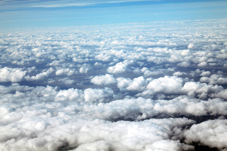 View from the airplane above the clouds