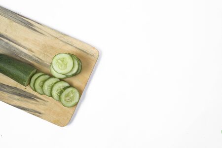 Cucumber on a wooden plank on a white backgroundの写真素材
