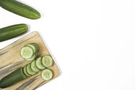 Cucumber on a wooden plank on a white backgroundの写真素材
