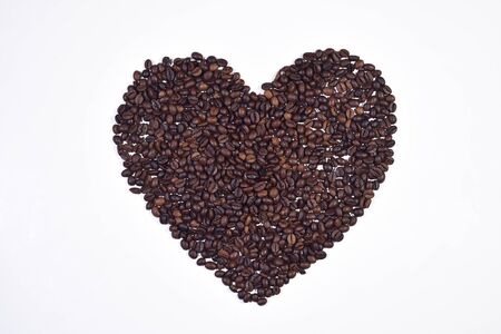 Image of heart shaped roasted coffee beans isolated on white backgroundの写真素材