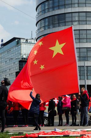 Prague, Czech republic - March, 28th 2016: Chinese girl holding flag during Chinese President Xi Jinping arrives in Pragueのeditorial素材