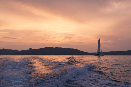 Yacht - Catamaran in the ocean. Sailing at sunsetの写真素材