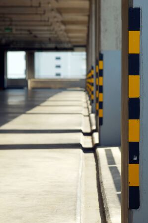 Yellow and Black traffic sign in parking building