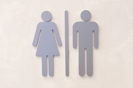 Grey woman and man sign one the wall
