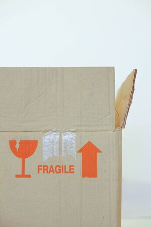 Open paper box with fragile symbol on white backgroundの写真素材