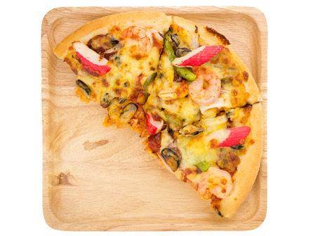 Seafood pizza on wooden plage on white isolated background from top viewの写真素材