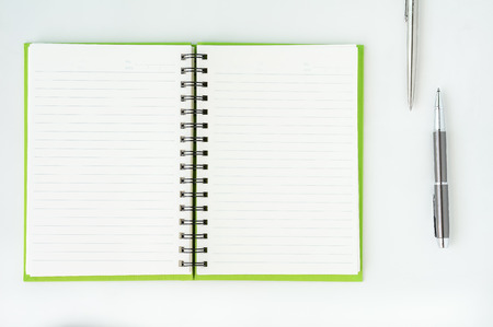 Open notebook with metallic ball pen. Top view.の写真素材