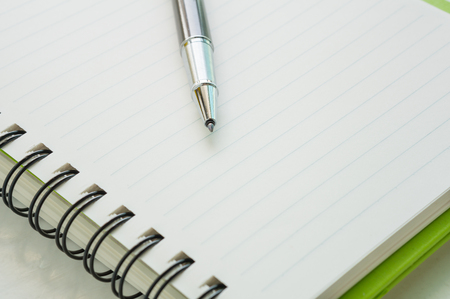 Open notebook with metallic ball pen. Selective focus.の写真素材