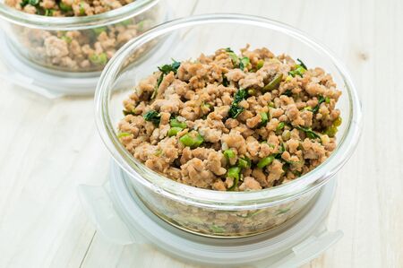 Close up of stir fried minced pork and basil on wooden background.Selective focusの写真素材