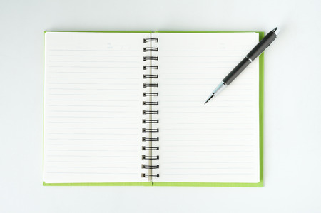 Open notebook with metallic ball pen. Top view.の写真素材