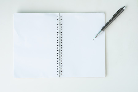 Open notebook with metallic ball pen. Top view.の写真素材