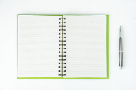 Open notebook with metallic ball pen. Top view.の写真素材