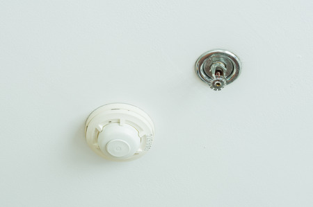 Fire sprinkler and smoke detection unit on white backgroundの写真素材