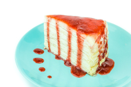 Mille crepe cake with strawberry sauce on white background. Selective focusの写真素材