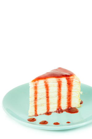 Mille crepe cake with strawberry sauce on white background with copy space.Selecitve focus.の写真素材