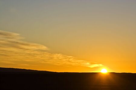 sunrise in the desert with cloudy skyの写真素材