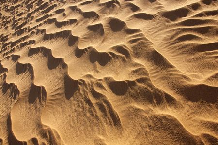 closeup of abstract rippled desert sand in daylightの写真素材