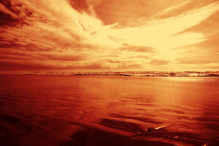 Red cloudy sky at the beach. Can be used as background.の写真素材