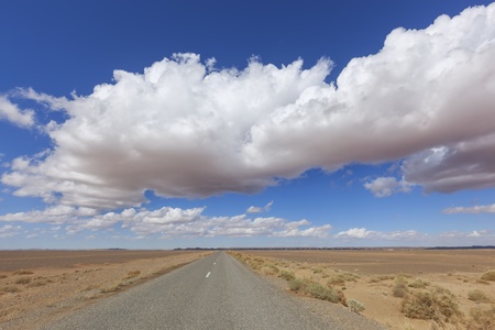 Road with desert landscape and cloudy blue sky in the Sahara desert of Morocco. の写真素材