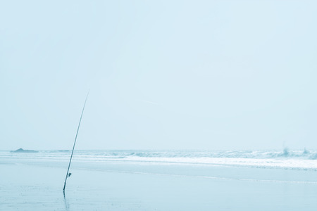 Fishing rod at the beach. Soft high key image.の写真素材