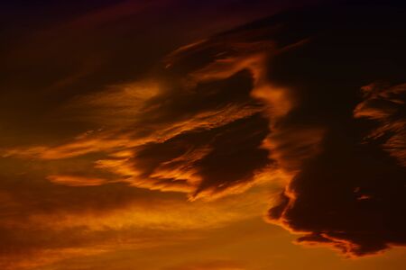 Dark red cloudy sky after sunset. Gloomy atmoshpere.