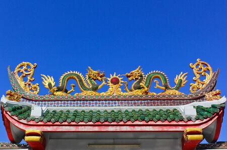 twin dragon in temple with blue skyの写真素材