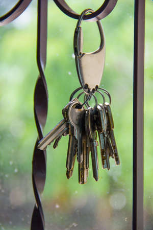 Keychain with keys Hanging on the grid iron cageの写真素材