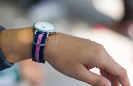 Female teenager wearing fashionable watch on the wrist.の写真素材