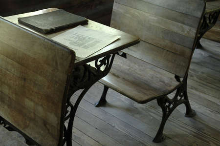 An old-fashioned wooden desk in a one-room school.の写真素材