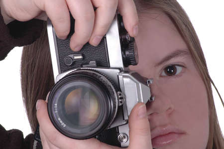 A woman positions a camera for a vertical shot. Half of the woman's face is visible.