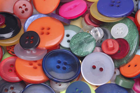 A closeup of a pile of colorful buttons. Good for use as a background.