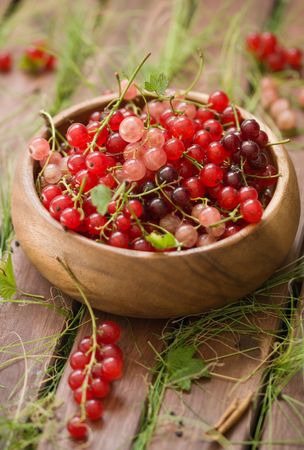 berries of a currant in a wooden bowl 