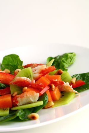 Seafood salad with  crab meat,kiwi,papaya,pepper and spinachの写真素材